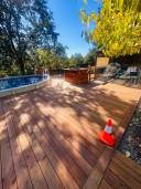flying over wooden deck with outdoor spa pool, luxury backyard